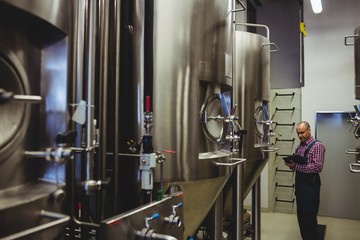 Owner examining machinery at 