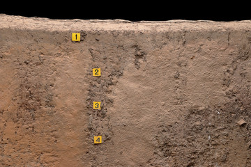 layer of ground with number in archaeological hole of prehistori