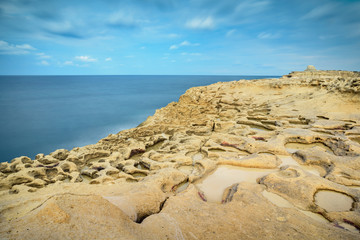 Rocky beach in Gozo, Malta. Xwejni Bay with view for lunar hill