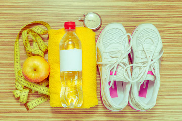 Shoes and sports equipment on wooden floor, top view