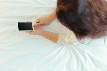 Woman with modern mobile phone in hands