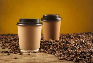 Paper cups of coffee on brown background