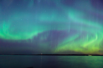 Northern lights over lake in finland
