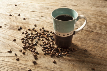 Glass mug of coffee on wooden background