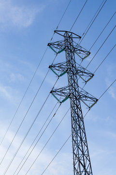 High voltage pole against blue sky