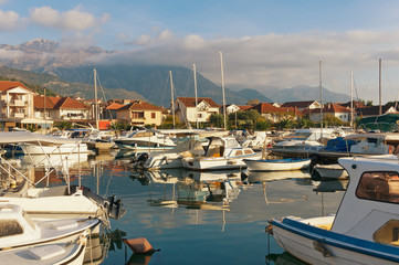 Fototapeta na wymiar View of boat harbor in Tivat city with Lovcen mountain in the background. Montenegro