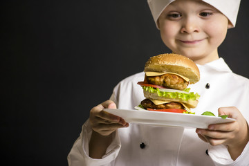 funny boy chef cooked hamburger