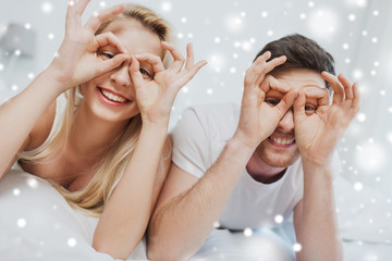 happy couple lying in bed at home