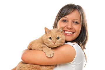 Young woman smiling at camera with red haired domestic cat, isol