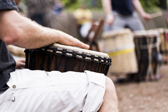 man playing the bongos, a traditional percussion instrument of African music