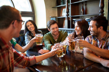 happy friends drinking beer at bar or pub
