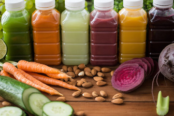 Obraz na płótnie Canvas bottles with different fruit or vegetable juices