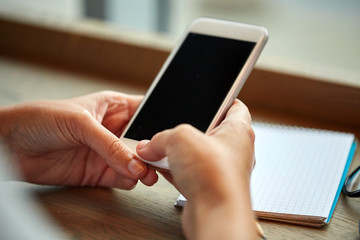 close up of woman texting on smartphone