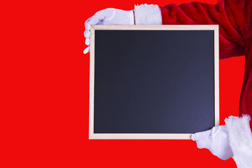 Santa claus with slate on red background
