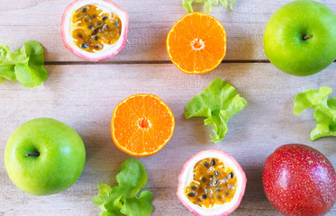Top view of healthy fruits and vegetable concept on a wooden background.