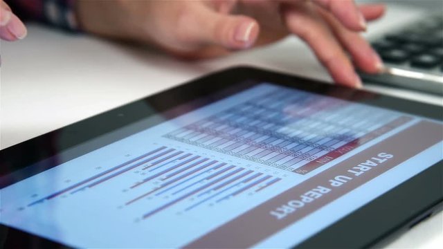Accountant Viewing Financial Reports On Digital Tablet