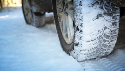 Car on the winter road in the wood. Winter tires