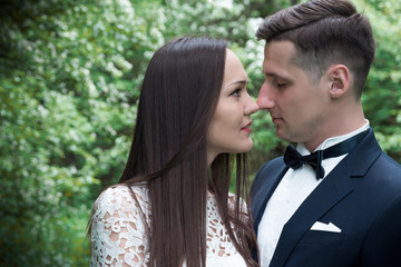 bride and groom kissing in the woods