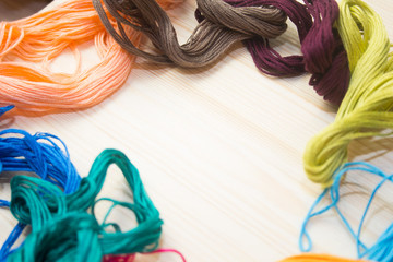 embroidery floss on wooden background. handmade concept