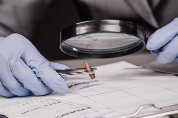 Detective through a magnifying glass looking at a evidence
