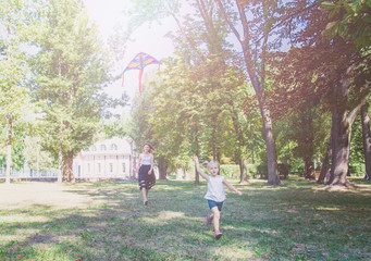 Fototapeta premium Young woman and girl flying a kite