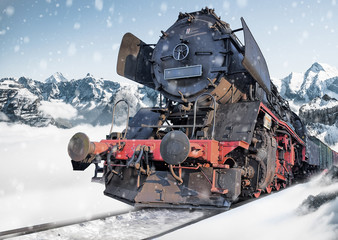 Classic locomotive train on snowy railway amidst the mountains