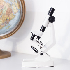 White microscope and globe