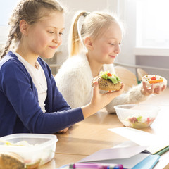 Young girls eating healthy sandwiches