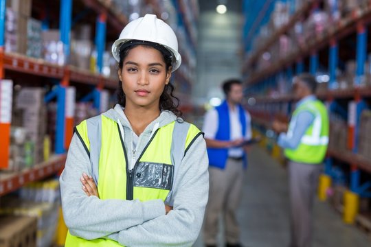 Female warehouse manager standing with arms crossed
