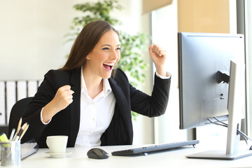 Excited executive watching a computer monitor