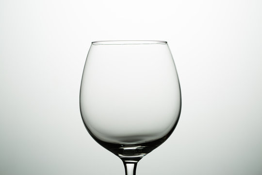 Empty glass for wine on gray background