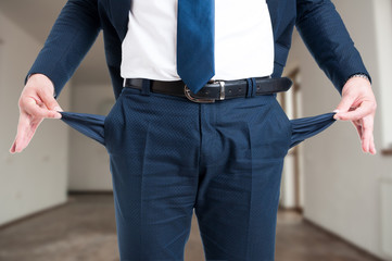 Closeup of male realtor showing his empty pockets