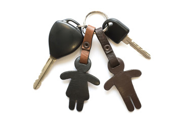 Car key and leather keychain on white background.