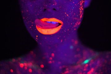 Portrait of Beautiful Fashion Woman in Neon UF Light. Model Girl with Fluorescent Creative...