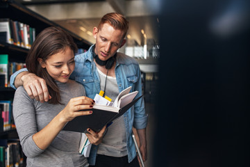 Two young university students in library