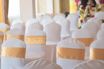 Fototapeta na wymiar beautiful chairs decoration with ribbon in wedding event hall,se