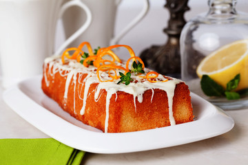 Christmas cake plum  food white chocolate, orange zest, thyme, close-up still life with tea and lemon