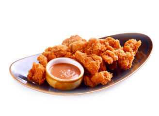 Fried chicken with sauce on white background