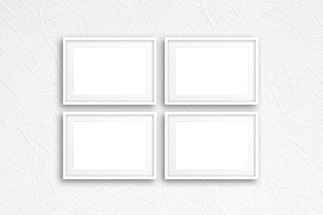 Four blank photo frames on modern textured wallpaper, interior decor mockup