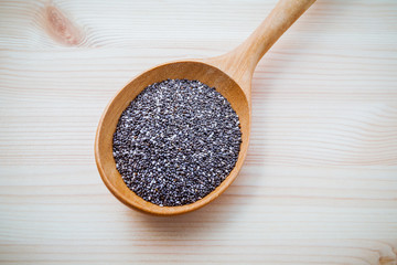 Nutritious chia seeds in wooden spoon for diet food ingredients