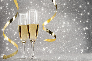 Champagne New year's eve, silver background, golden ribbon