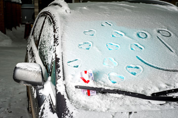 Money is stuck under the wiper, symbolizing the car expenses, snow winter