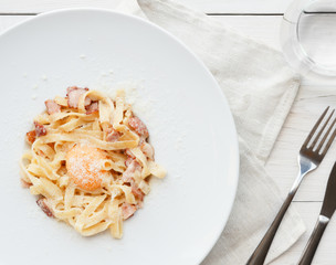 Traditional italian pasta carbonara with bacon and egg