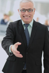 Mature friendly white-haired businessman in a modern office