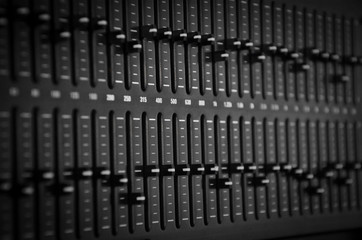 Part of an audio sound mixer with buttons and sliders