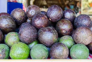 Ripe and raw avocado fruit for sale in a market stall near the street,Chiangmai,Thailand