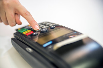 Close-up of cards servicing with POS-terminal, isolated on white background