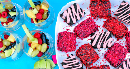 Champagne with fruit in a beautiful glass. Colorful Cakes on the occasion. Picnic table.