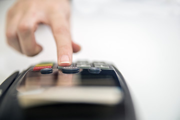 Close-up of cards servicing with POS-terminal, isolated on white background