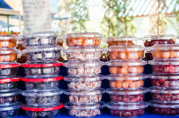 Mixed dried fruit in plastic box for sale in a market stall